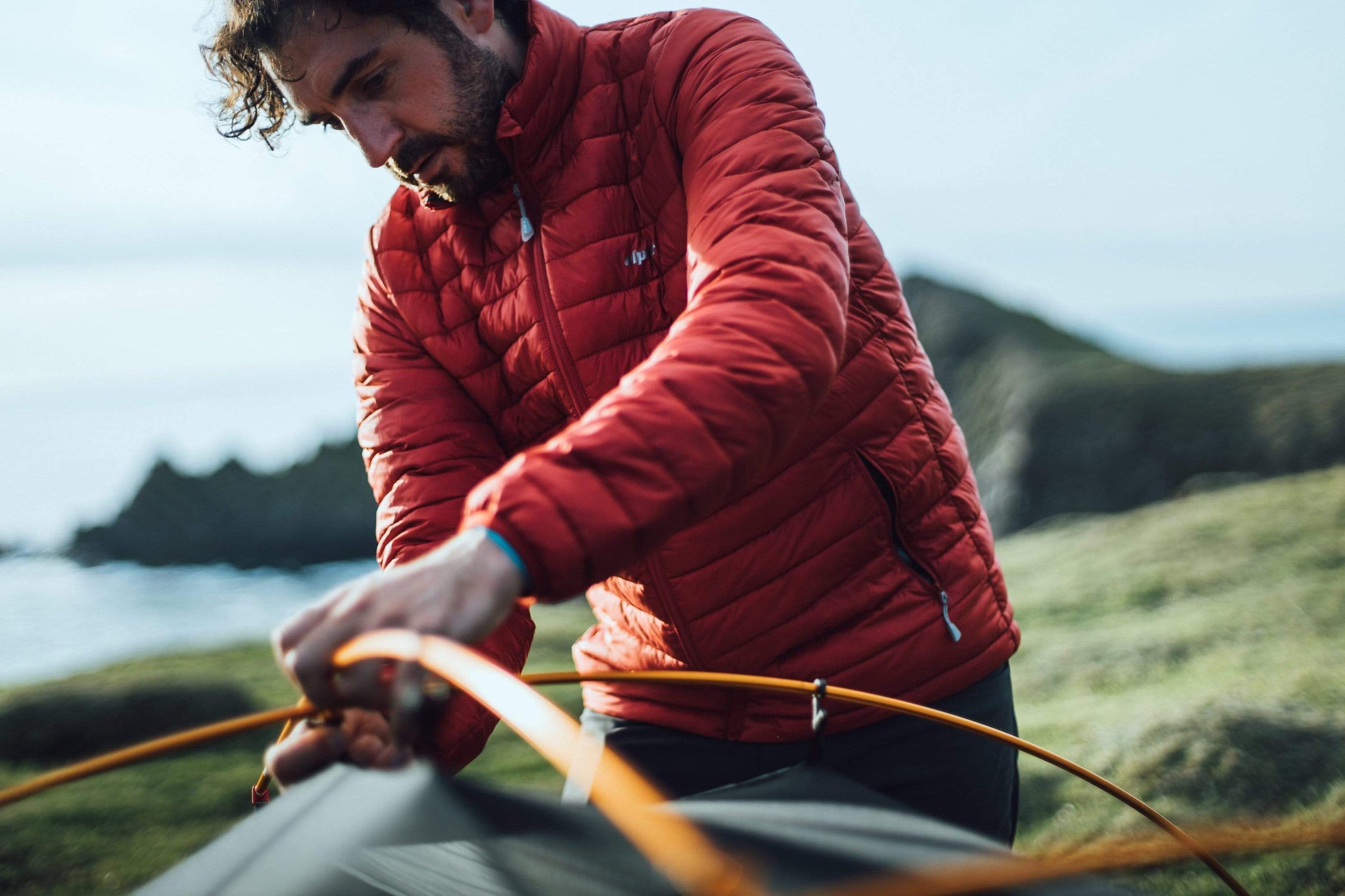 Carefully clipping tent poles in place when pitching