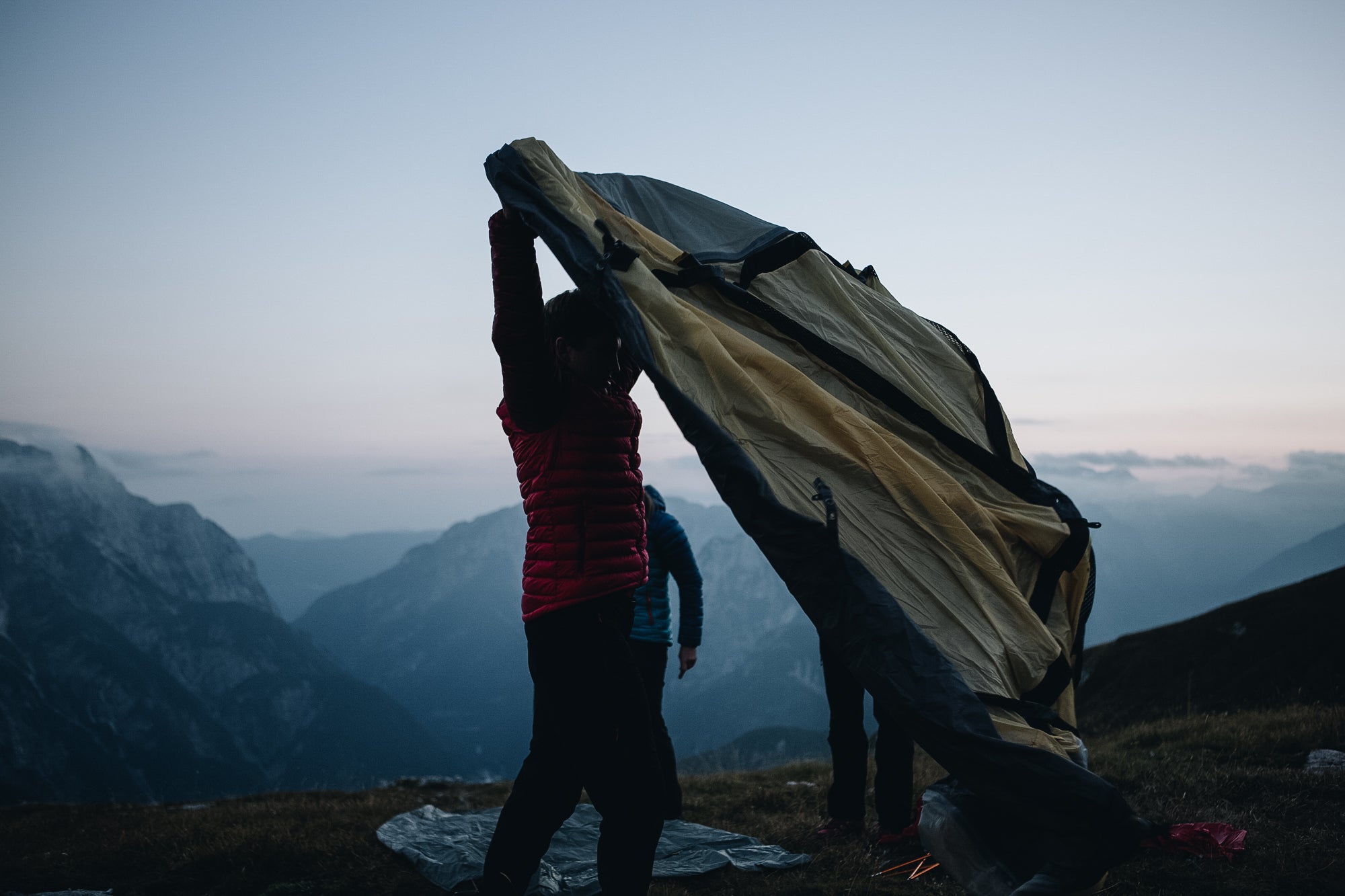 Two people putting up a 4 season mountain tent in the Slovenian mountains