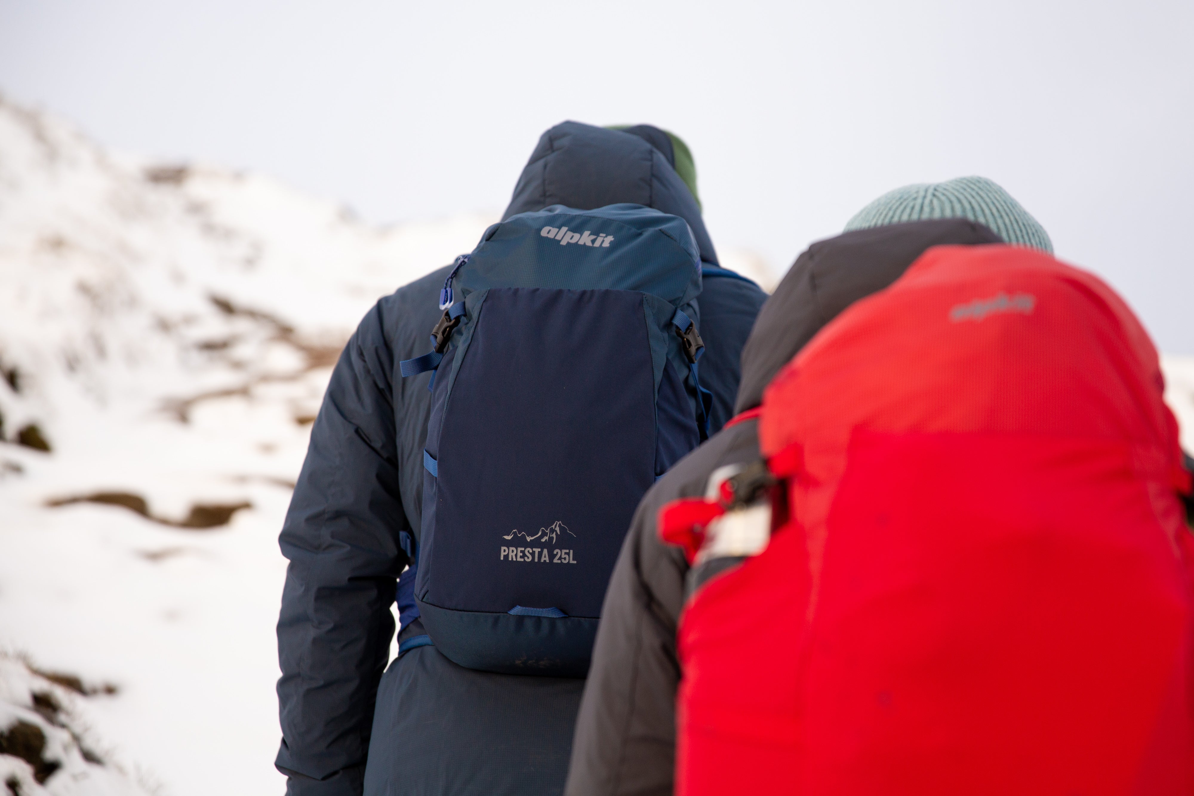 Two people walking with Presta 25 rucksacks across the Kinder Plateau in the snow