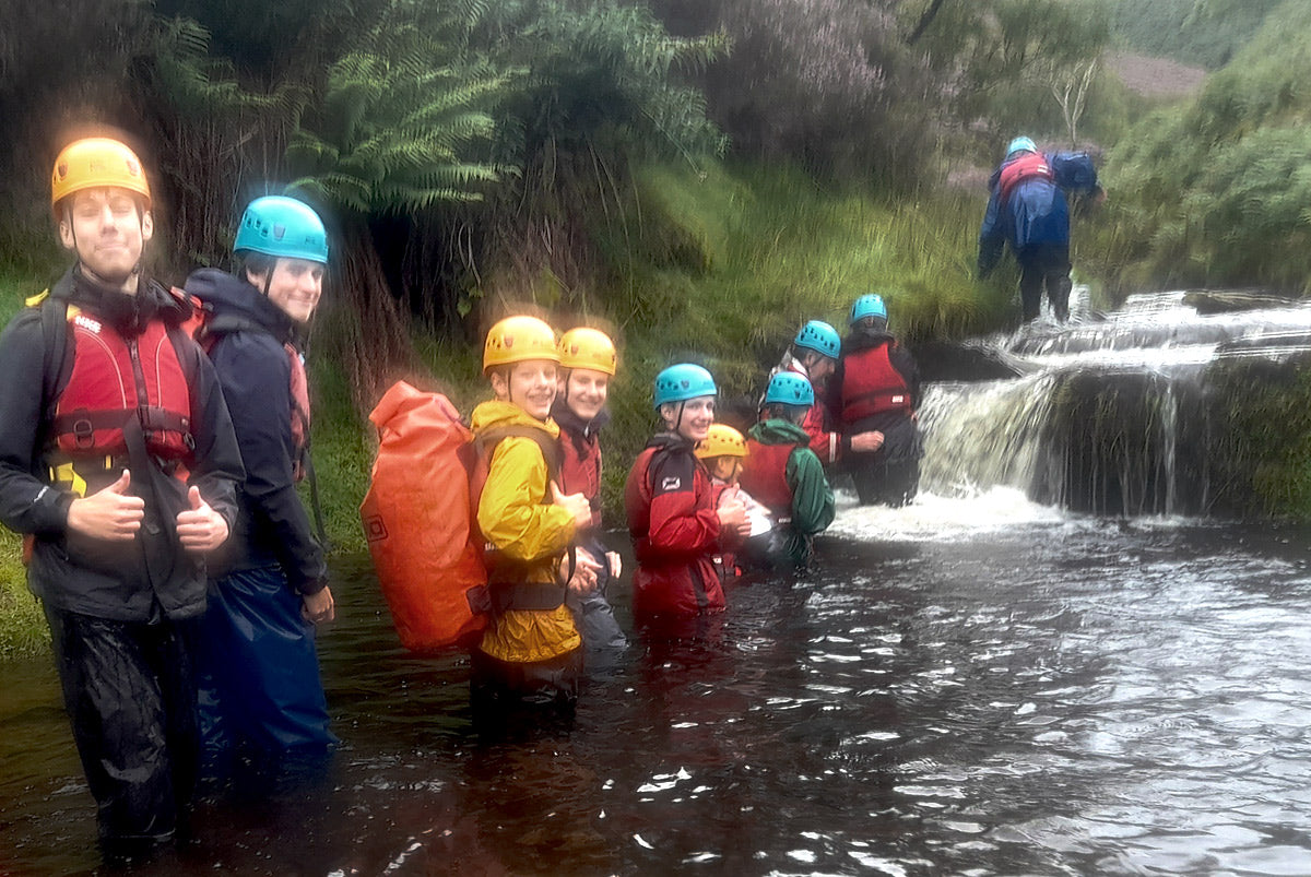 Kids in helmets gorge scrambling