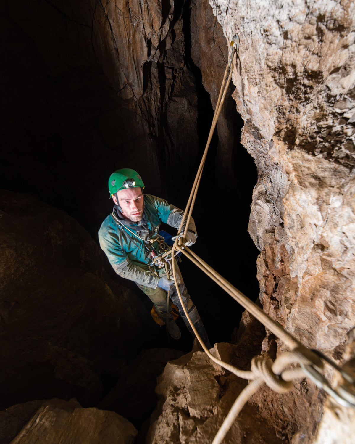 Caver rigging ropes as he descends