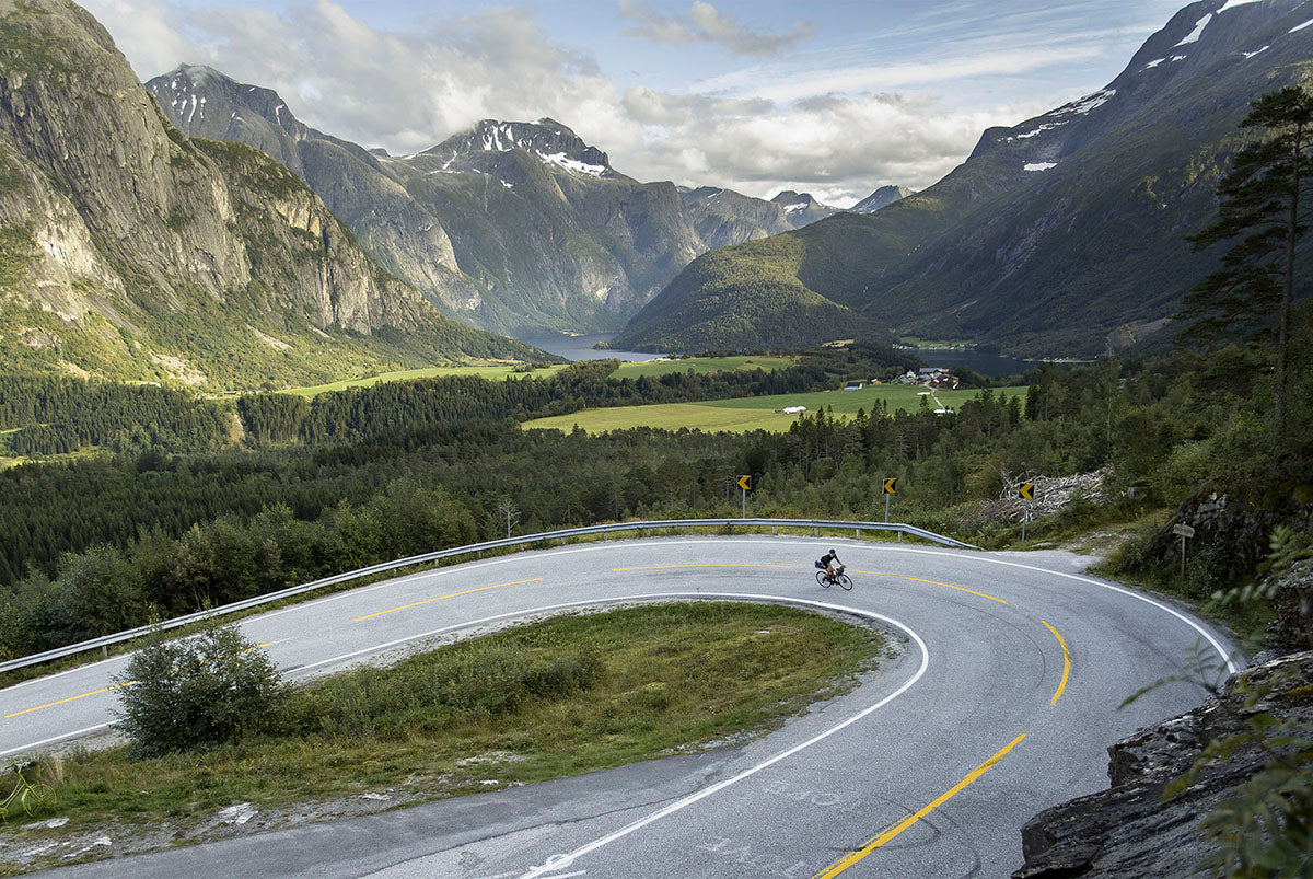 Road cyclist ascending Norwegian hairpins