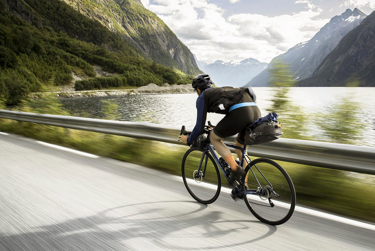 Fast cycle touring alongside Norwegian fjord