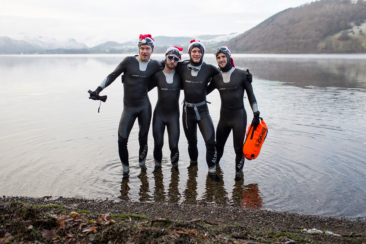 4 swimmers getting ready to wild swim in winter