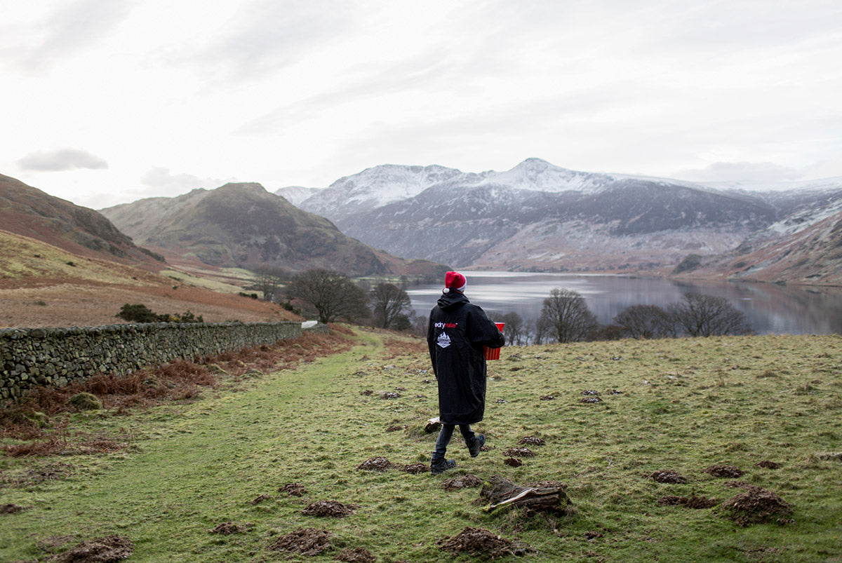 Winter wild swimmer dressed in a dry robe