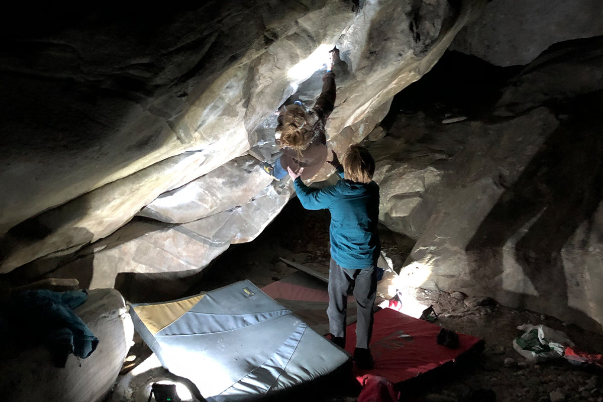 Climbers bouldering at night with floodlight