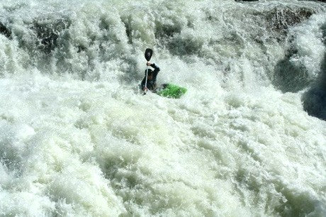 Kayaker in plunge pool after running waterfall