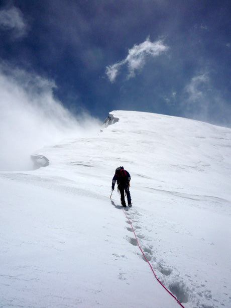 Climbing a snow ridge in winter