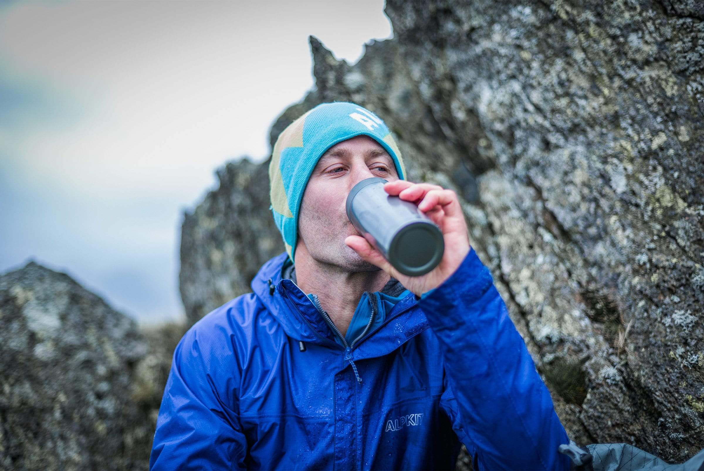 man drinking from clip flask