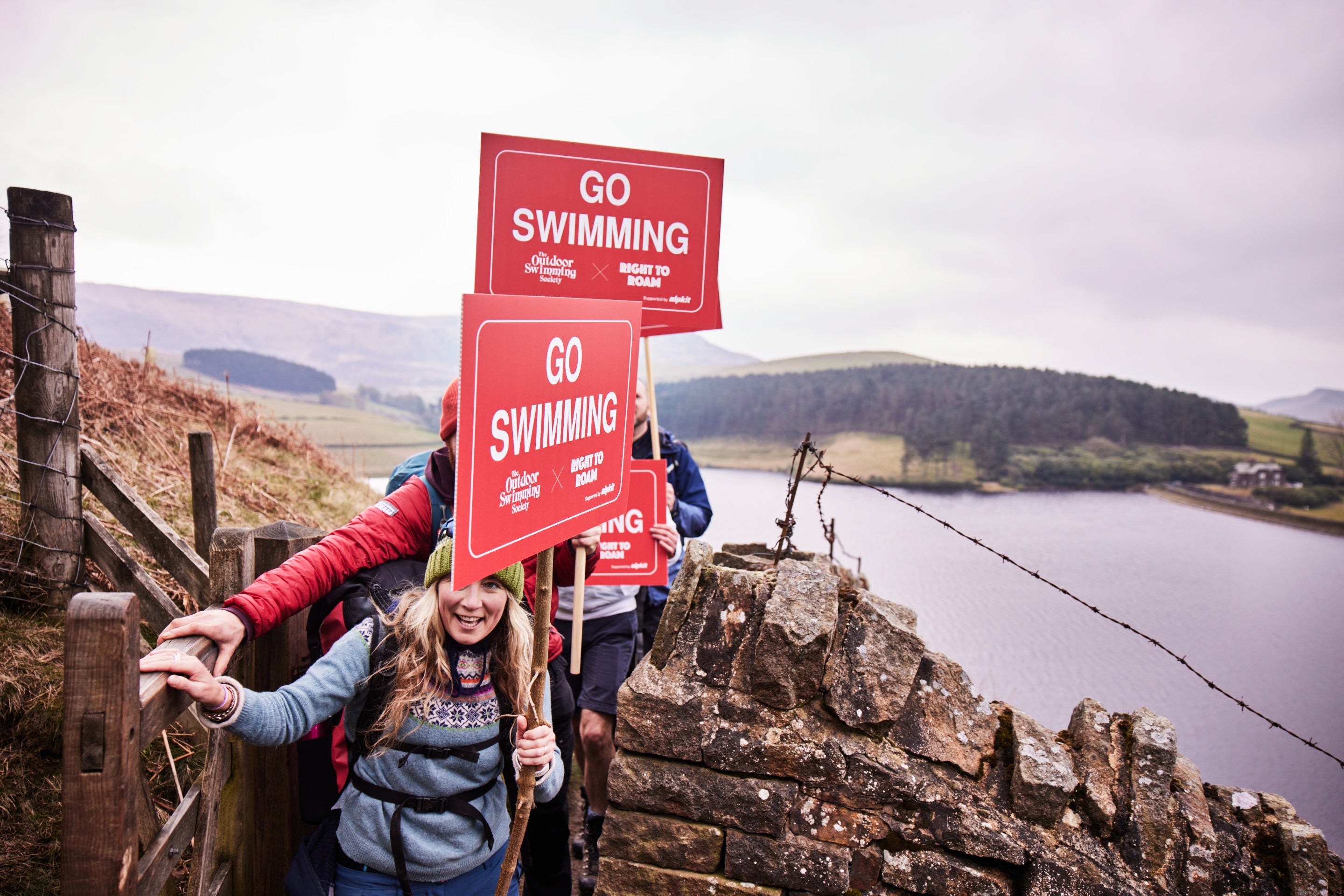 Go Swimming banners on the hike to the trespass swim