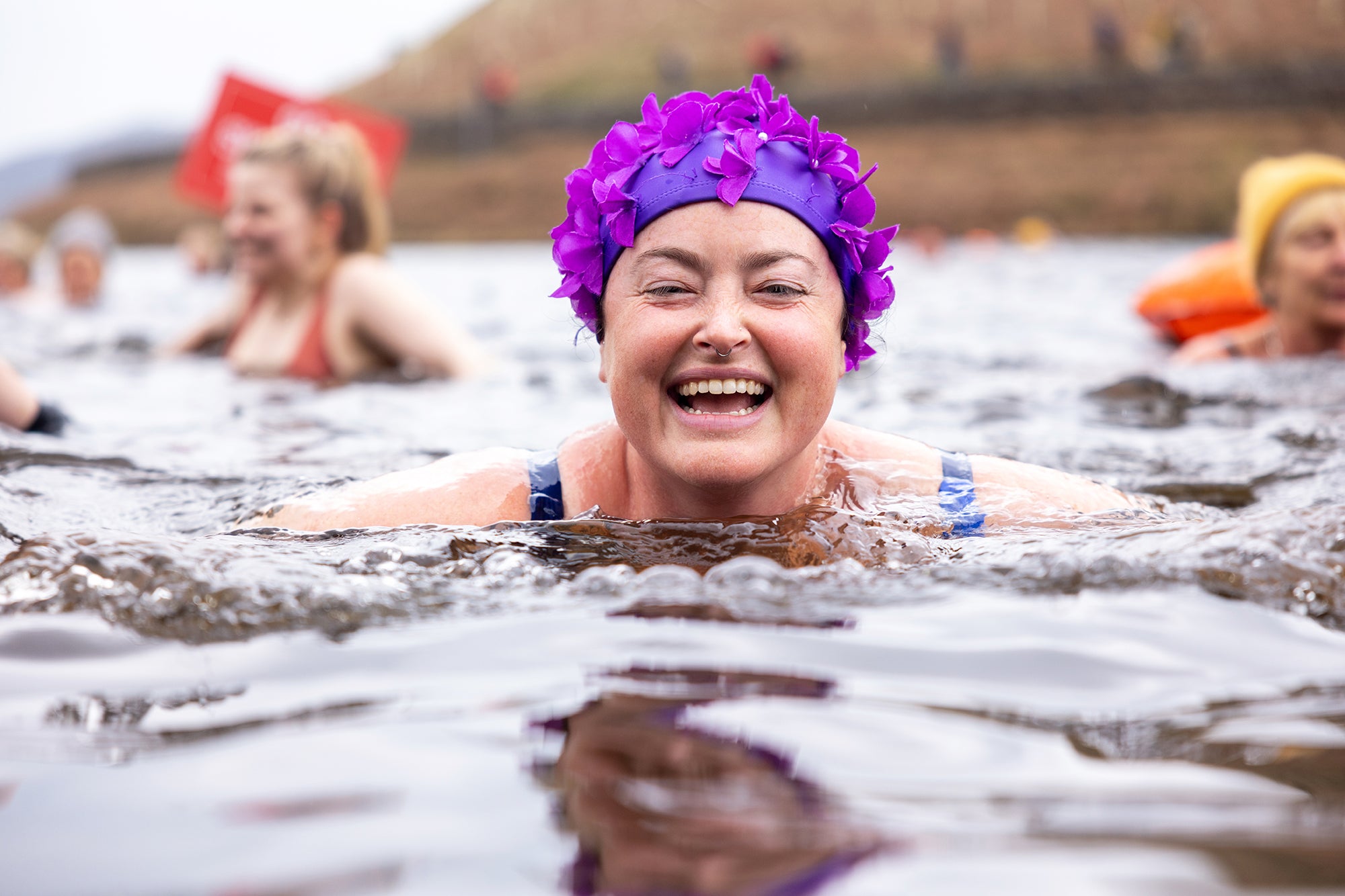 woman smiling whilst wild swimming