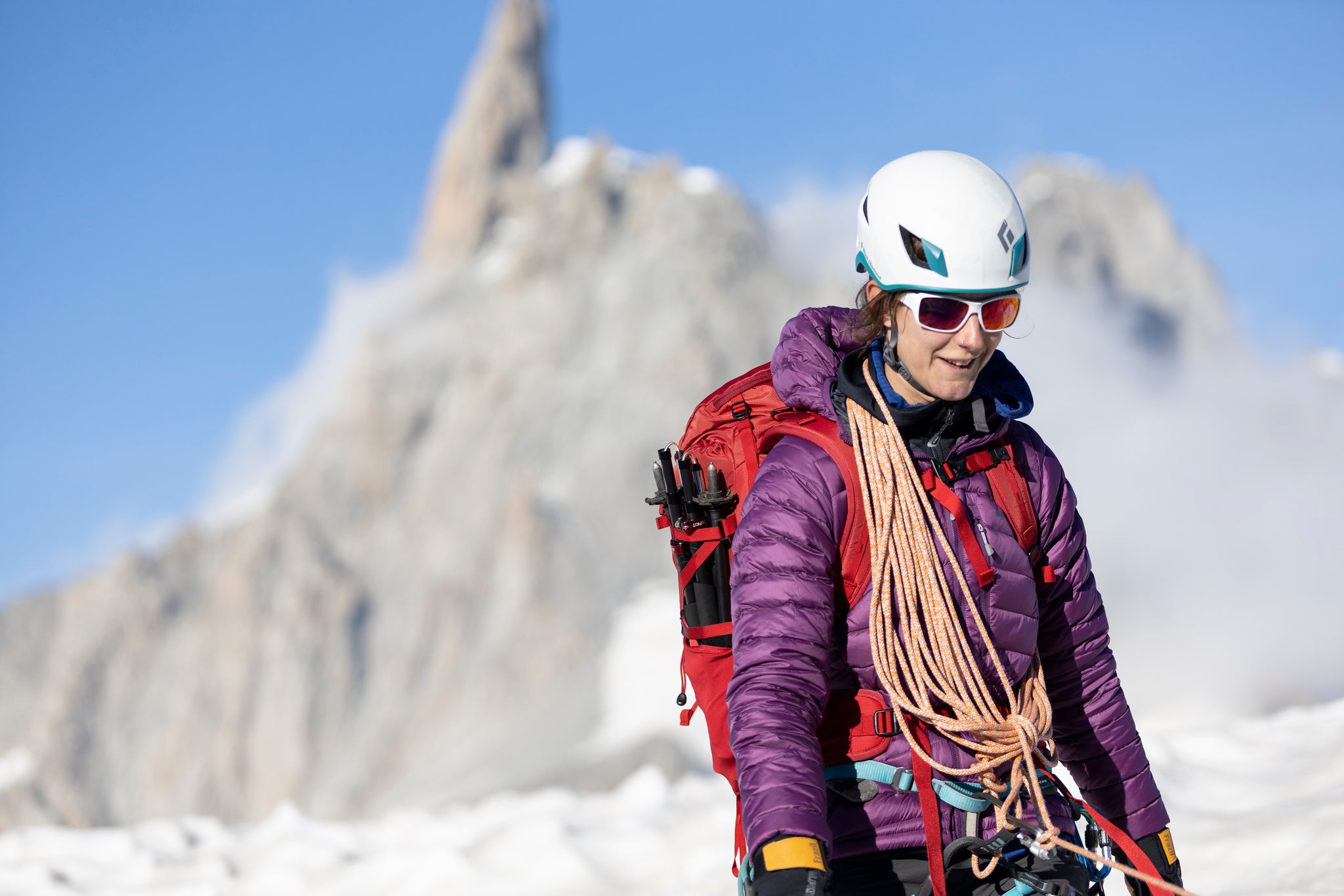 A woman walking in the Filoment micro baffle down jacket with stitch through contstruction