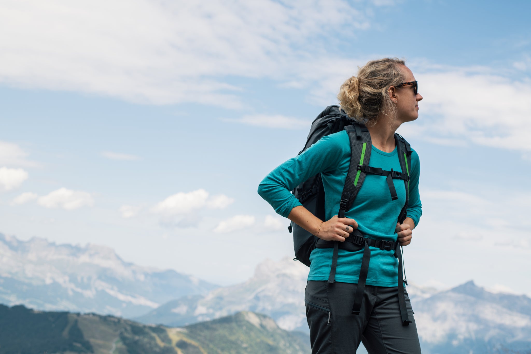 Woman trekking in the French Alps in a merino wool base layer