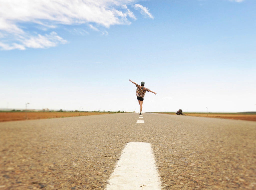 itzi walking down the middle of an empty road