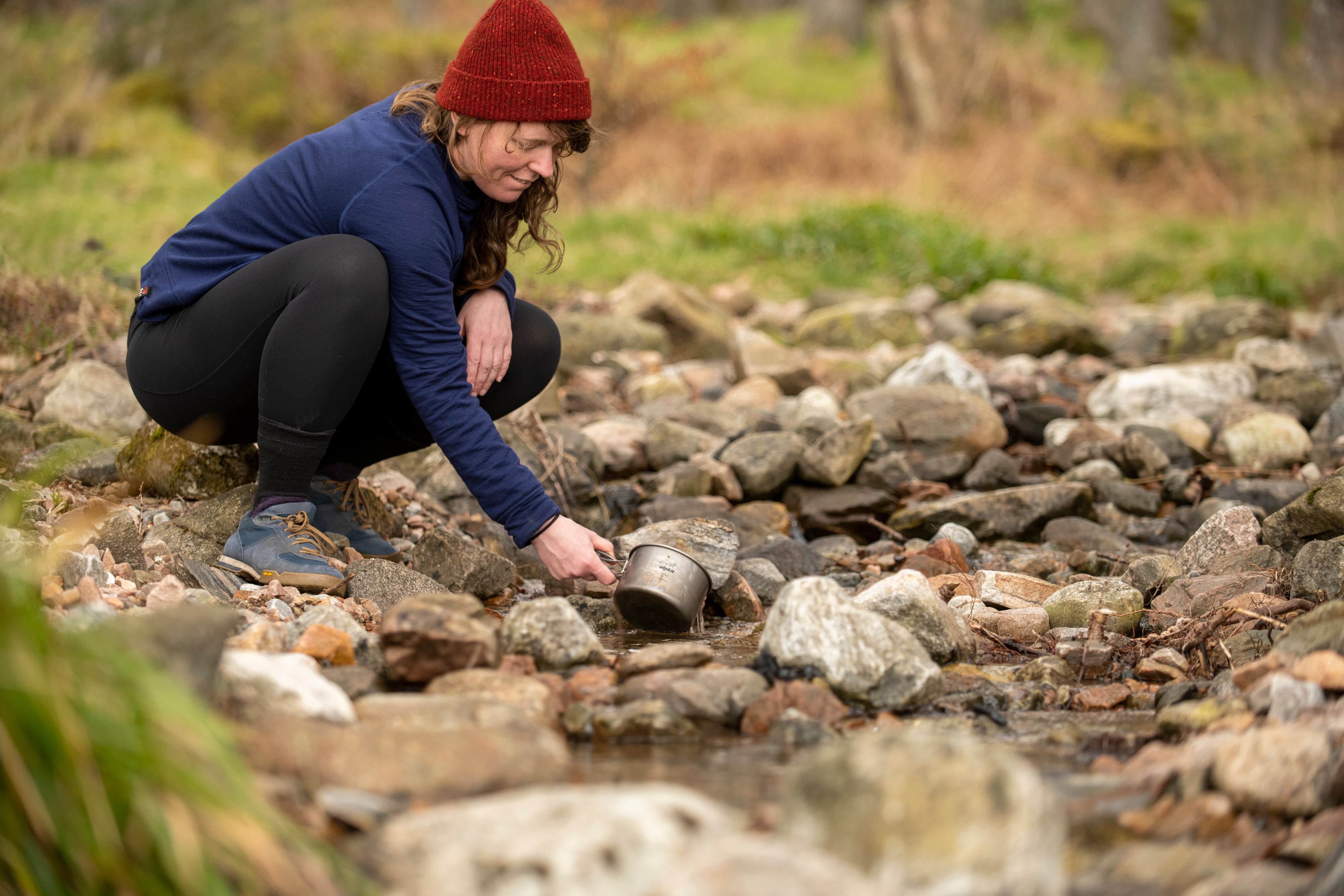 Jenny Graham washing up in a stream after bikepacking