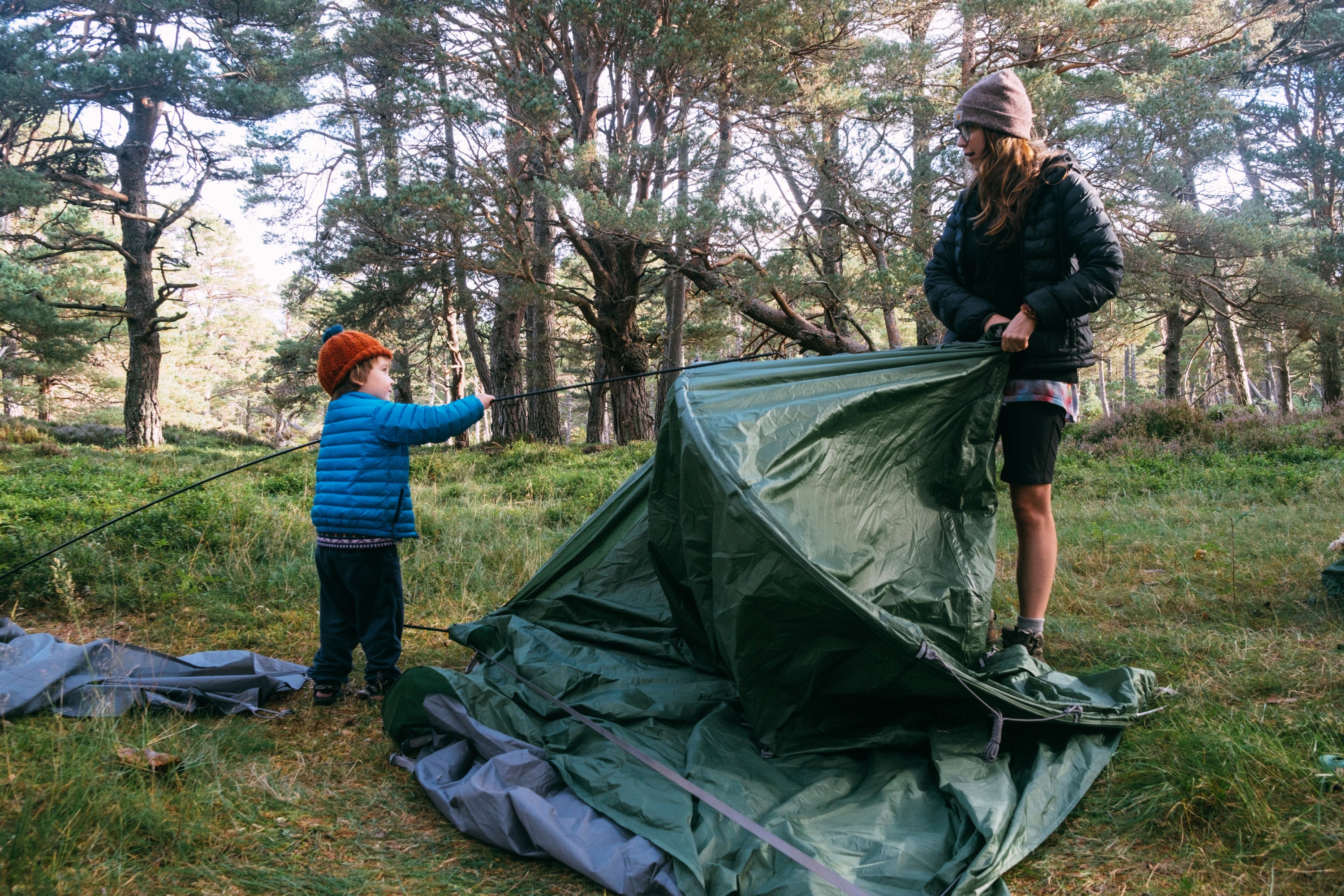 Mother and son putting a tent up