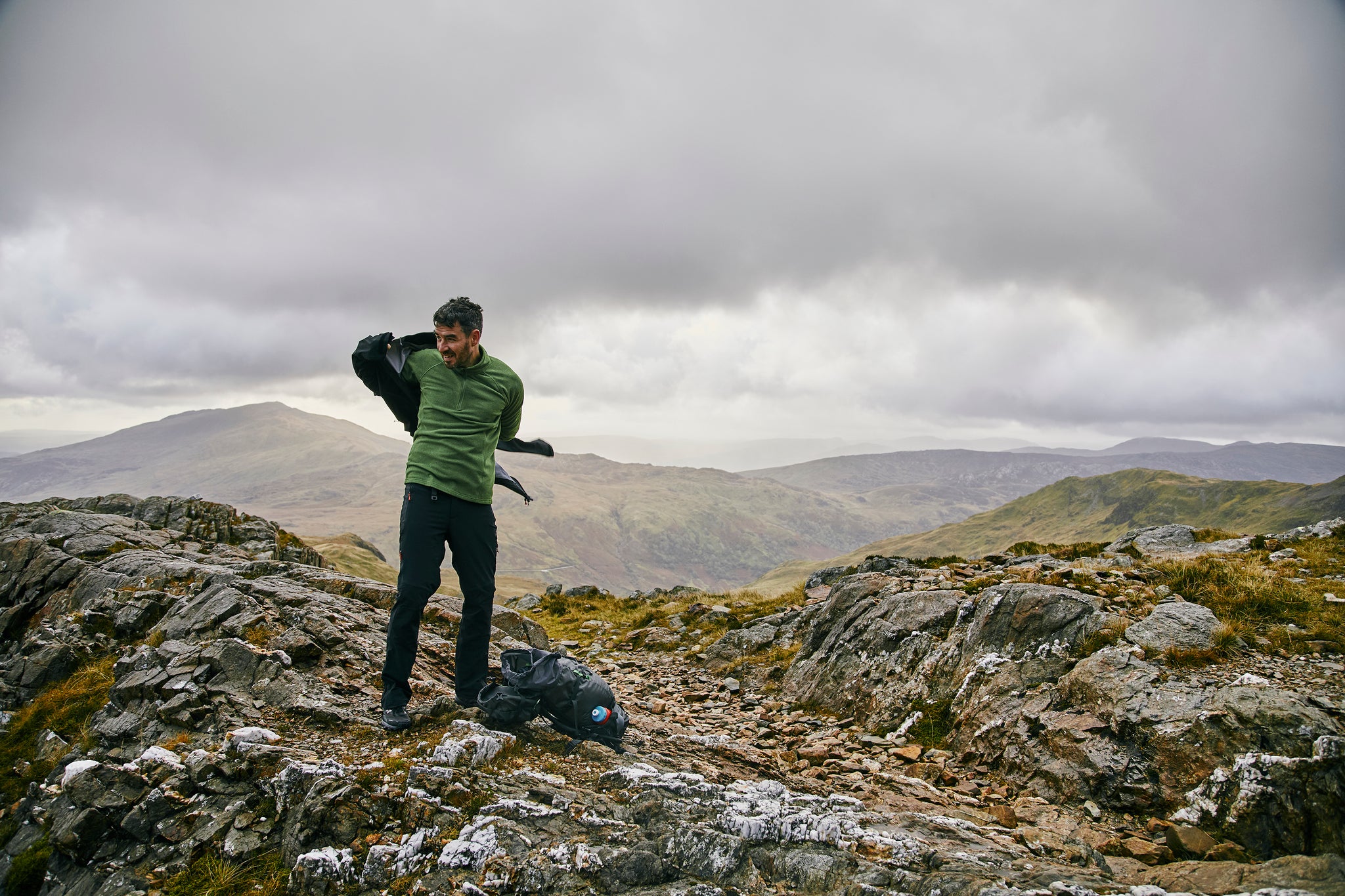 Putting a waterproof on in the mountains of Snowdonia