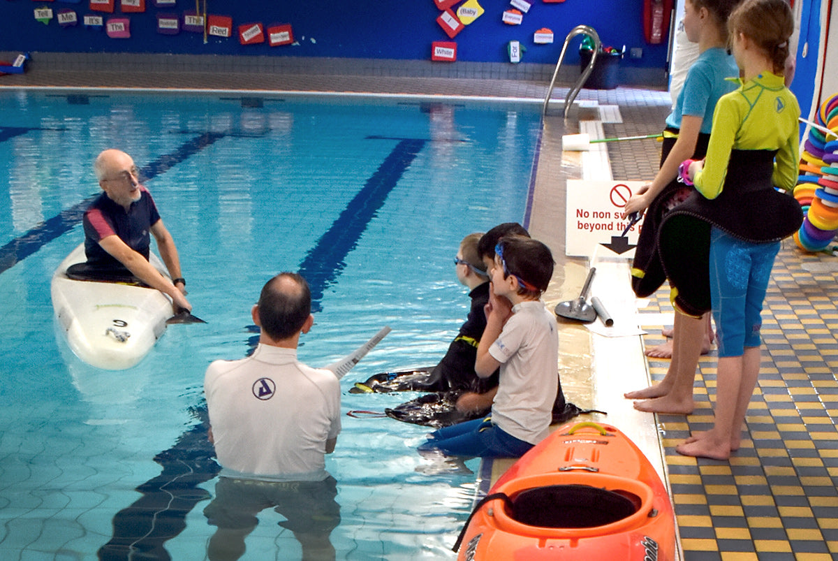 kayaker teaching skills in swimming pool