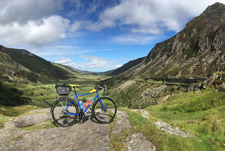 Steel framed touring bike with panniers in North Wales