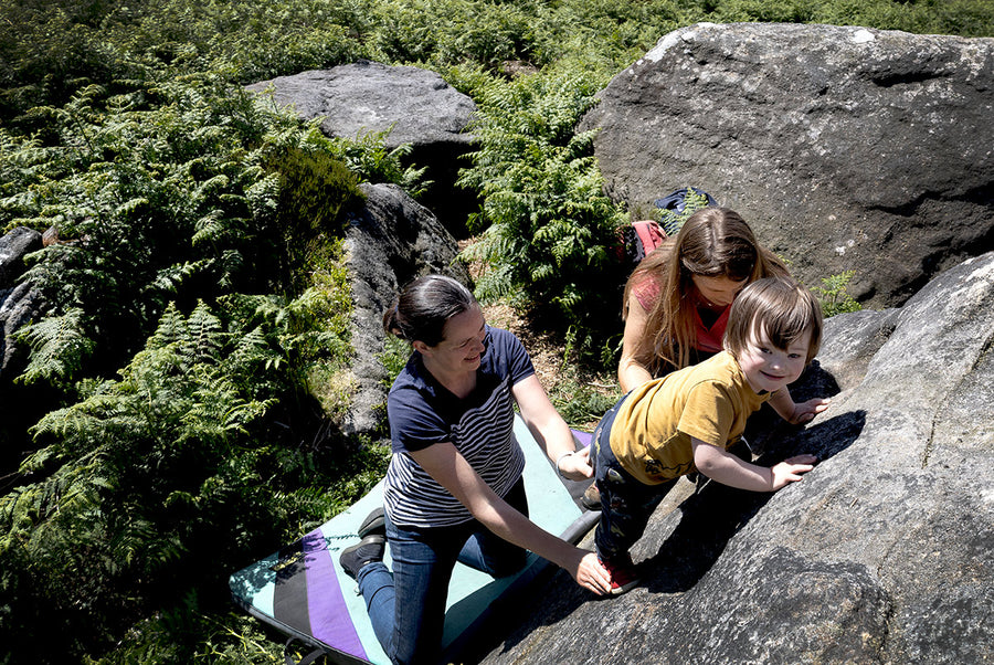 Child learning to boulder in the Peak District
