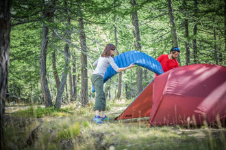 Trying to get a Dumo inflatable sleeping mat inside a tent in the woods near Chamonix