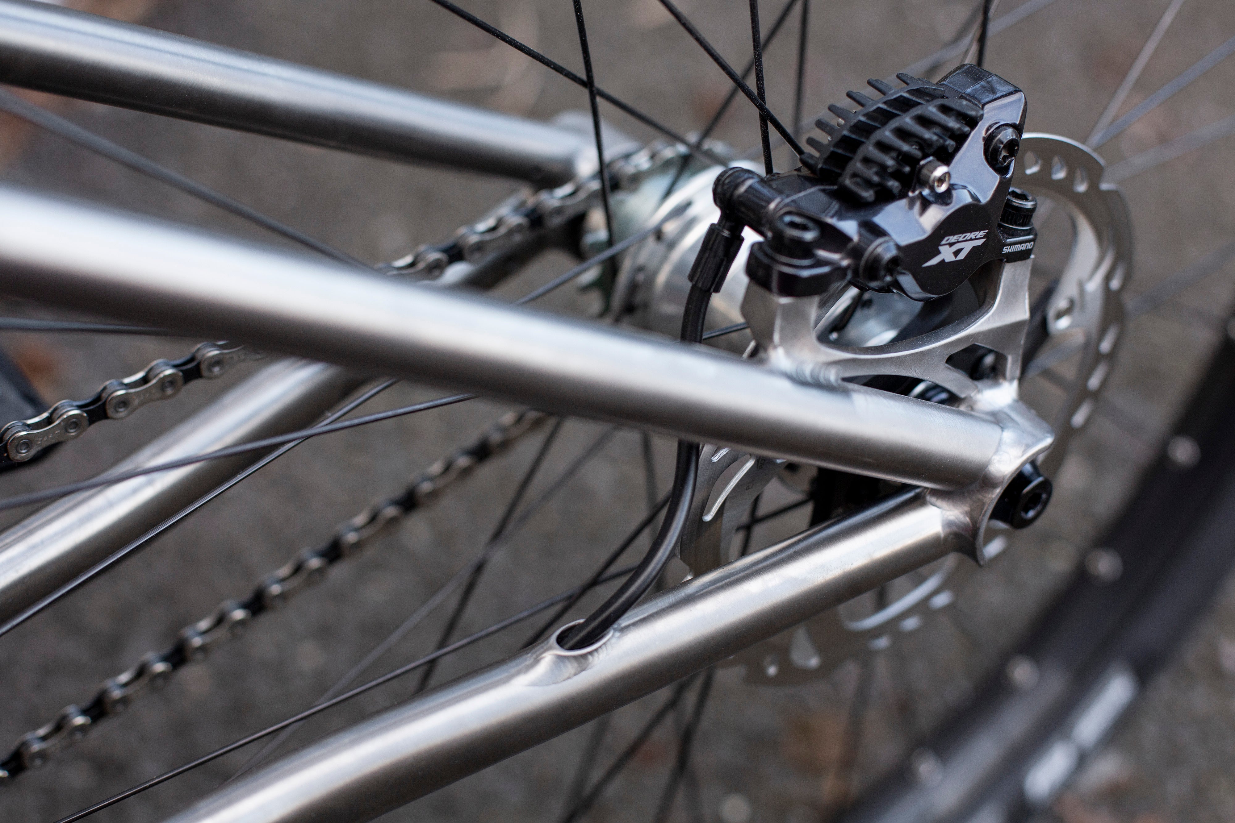 Close up of hydraulic breaks on custom Sonder titanium jump bike