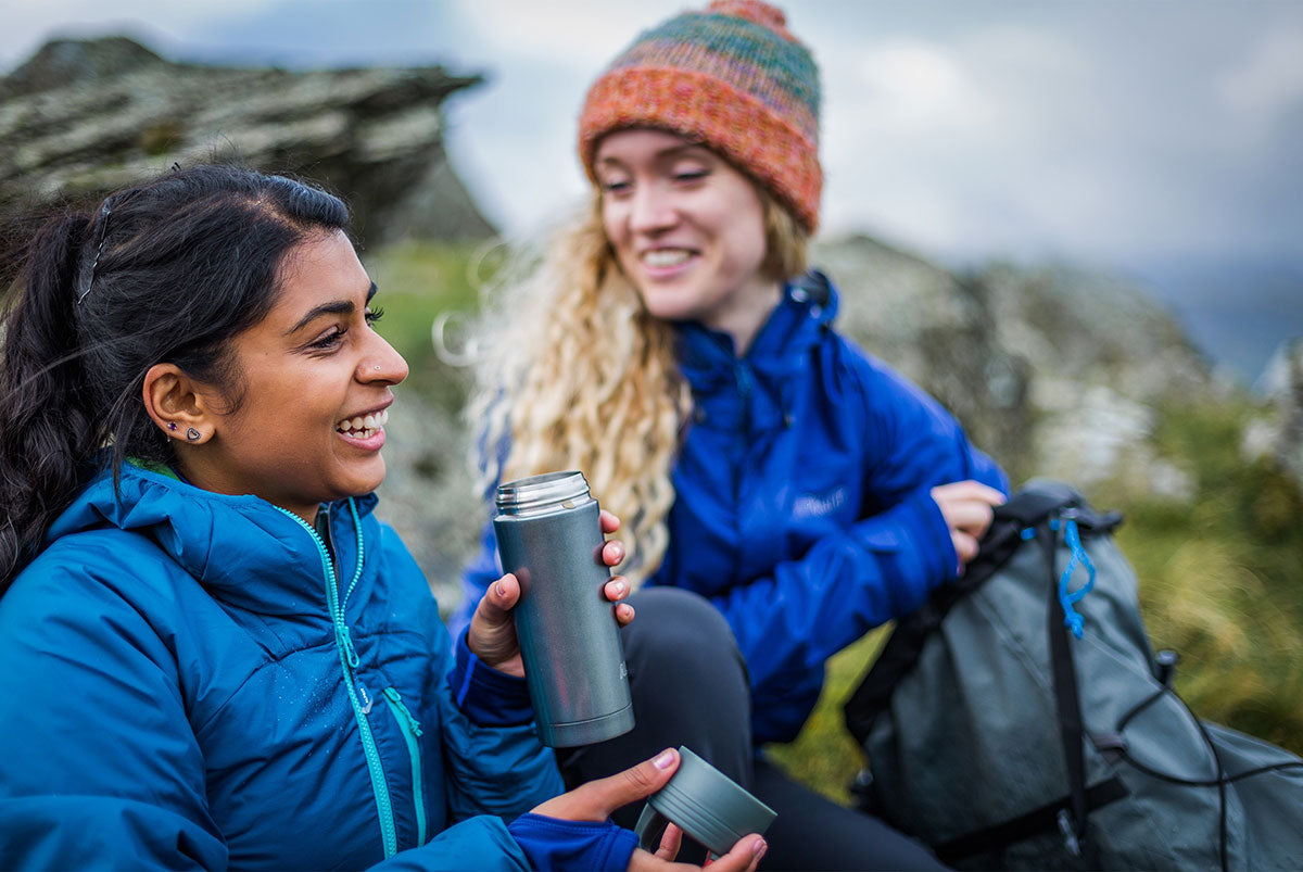 Drinking hot tea from a flask on a winter hike