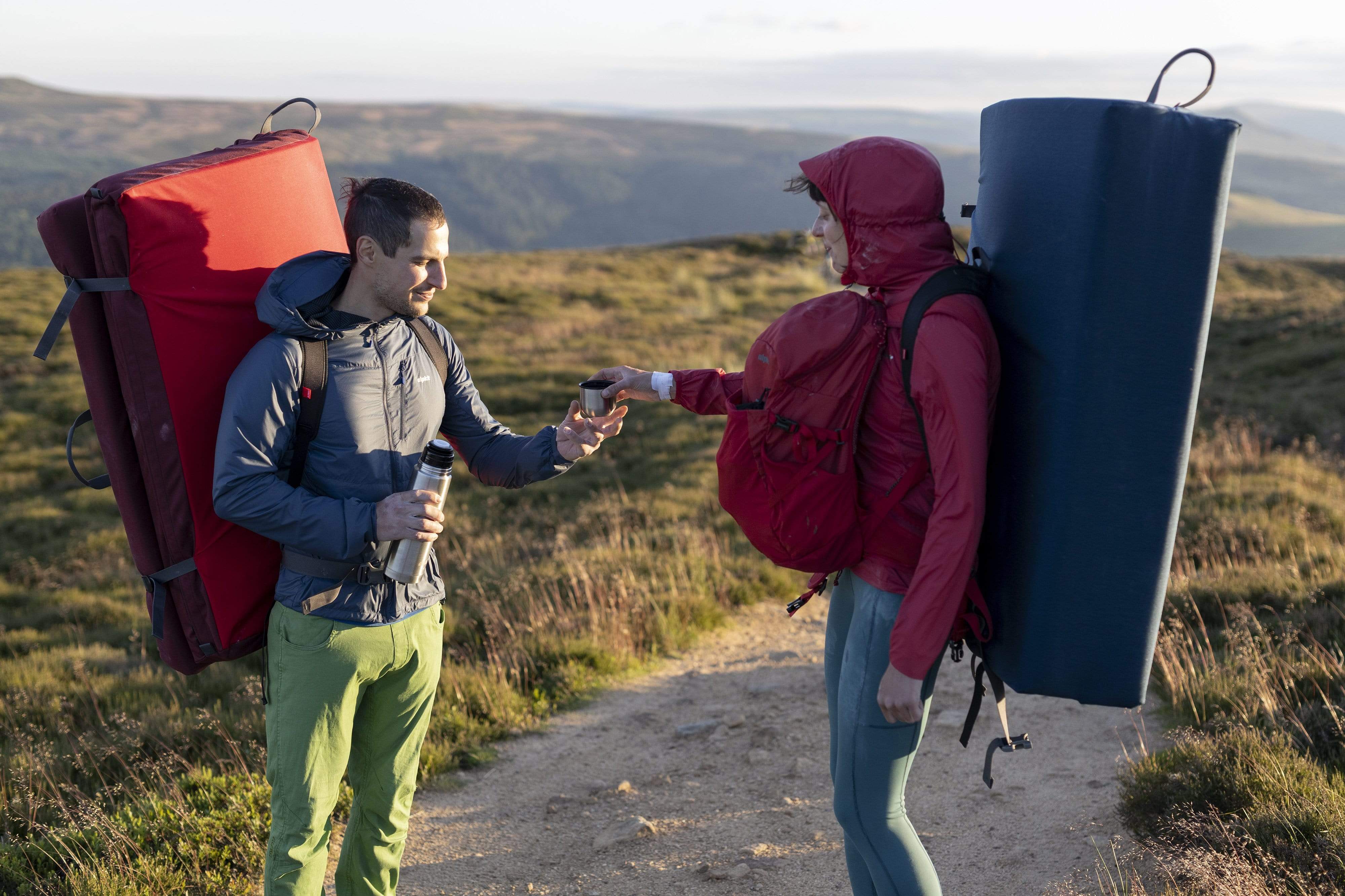 bouldering couple toasting with flask outdoors