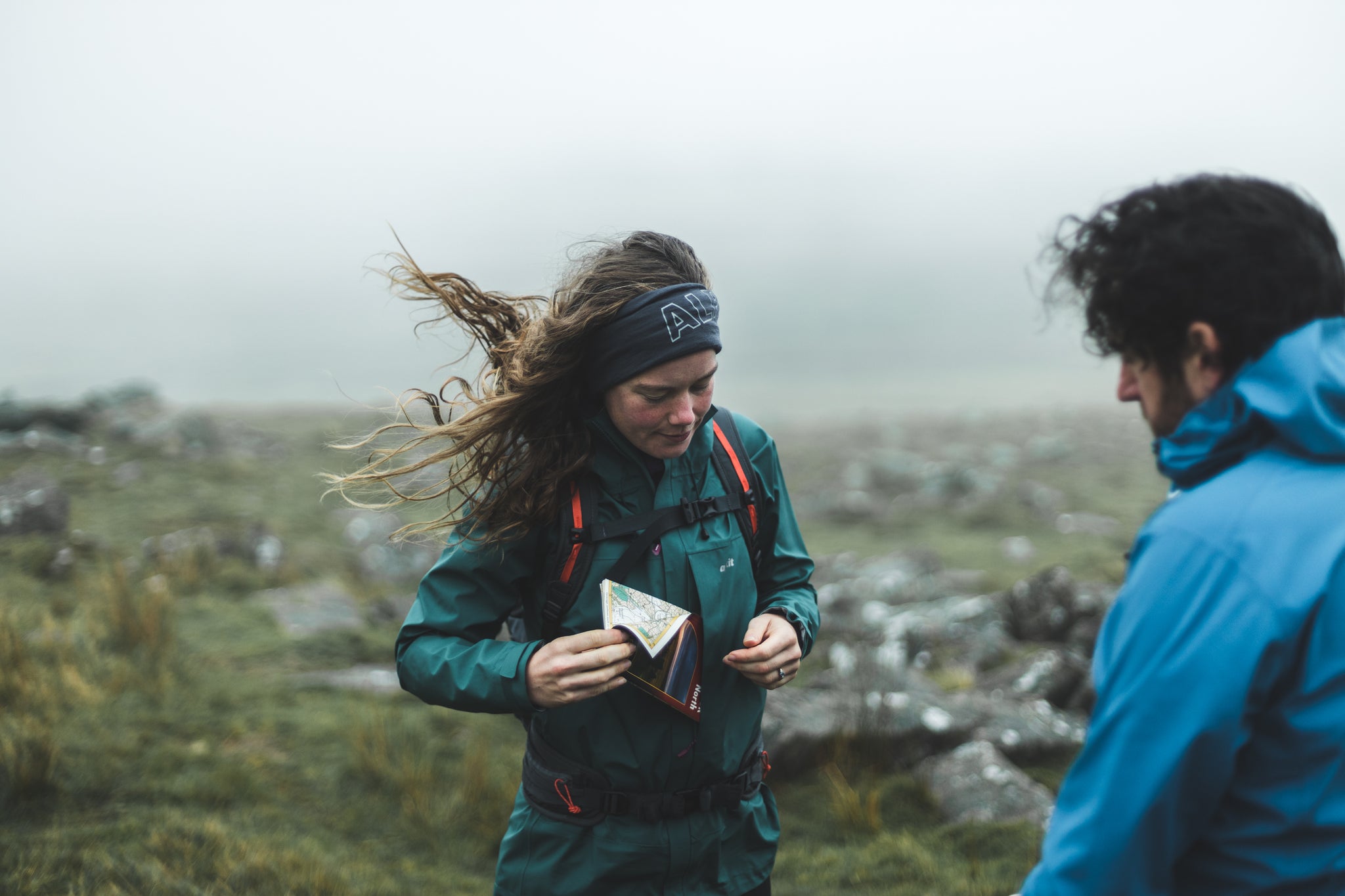 Putting a map in the pocket of the Fortitude hillwalking waterproof in Devon