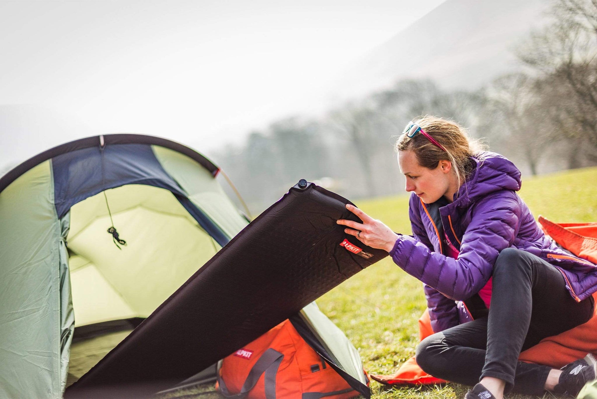 Pushing a Dirtbag self-inflating sleeping mat into the tent in the Peak District