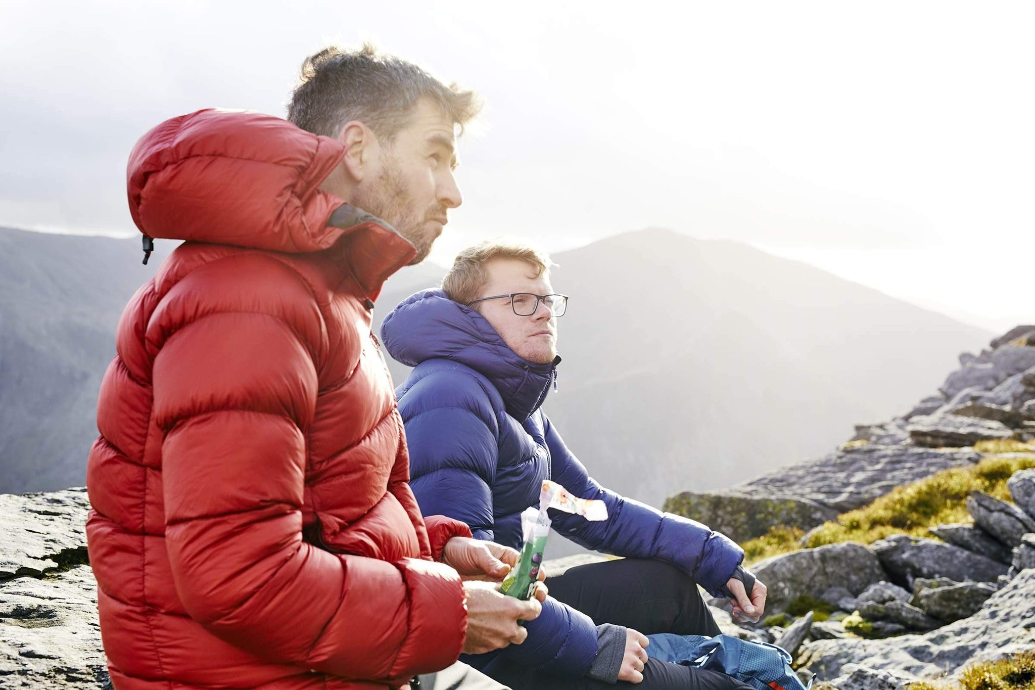 Two men sitting on top of a mountain in Snowdonia in the Fantom down jacket