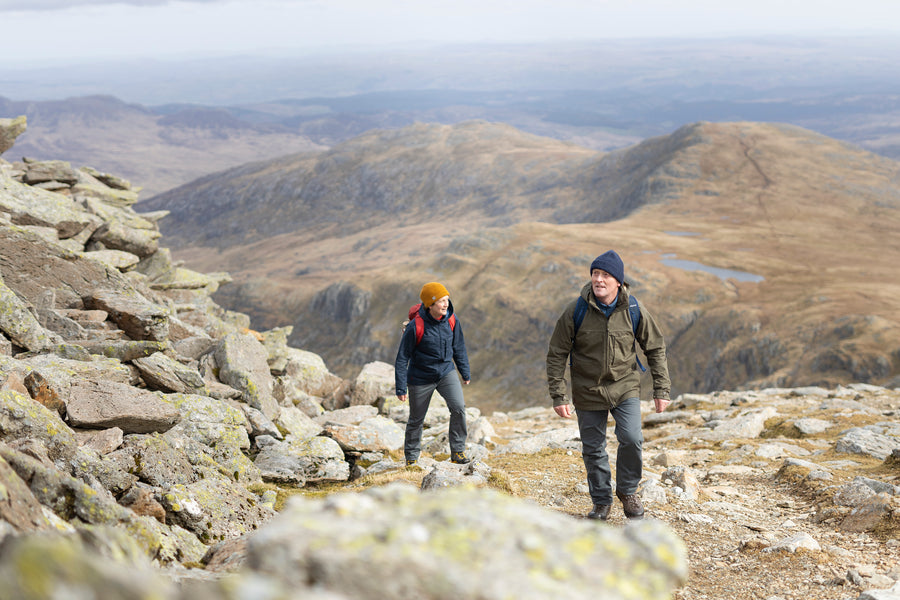 A man and a woman walking up Glyder Fawr and Glyder Fach in Snowdonia, wearing Ventile jackets