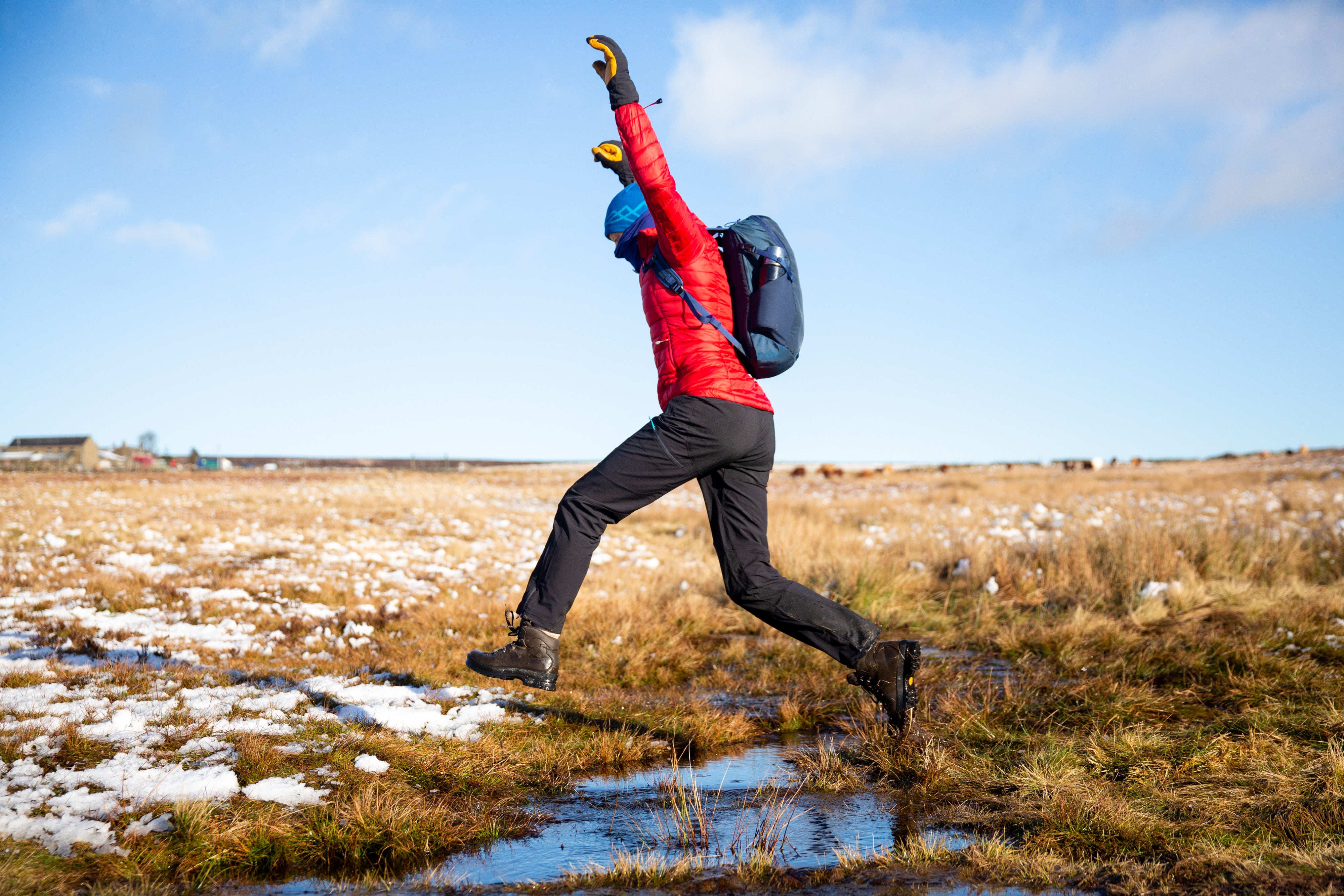 jumping over a bog in the Peak District with the Gnarl 15 rucksack