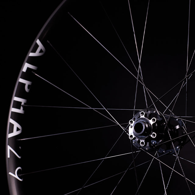 a close up of a bike wheel with a black background