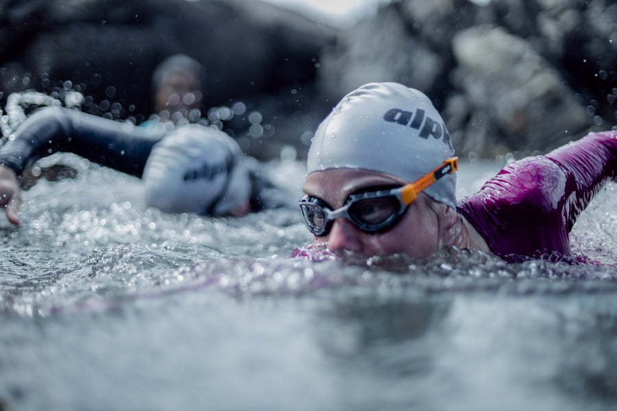 woman swimming in coniston cap and kidston goggles