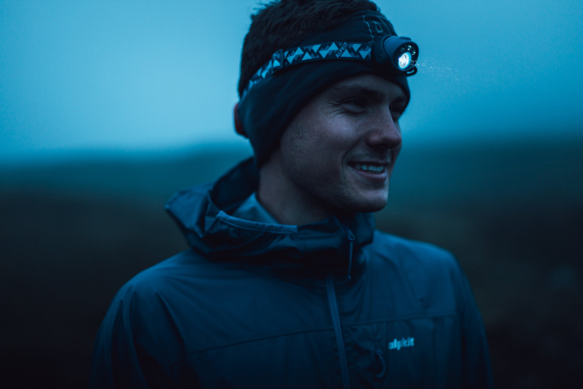 A man wearing a Gamma head torch for winter running