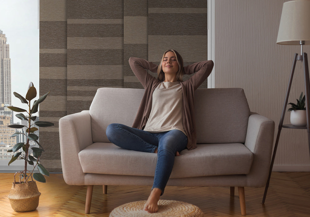 a person sit on sofa and relaxing with blackout blinds at the back