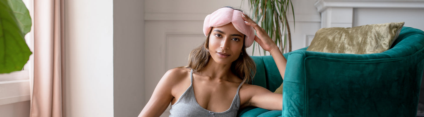 Mother holding Nodpod Sleep Mask against her head for the perfect sleep.