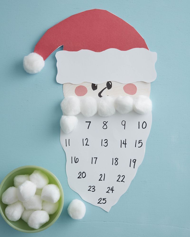 An advent calendar made to look like Santa with his beard made of cotton balls (his beard is the advent calendar!)