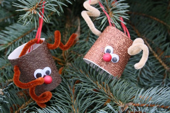 2 Christmas ornaments hanging on a tree that are tiny homemade reindeers.