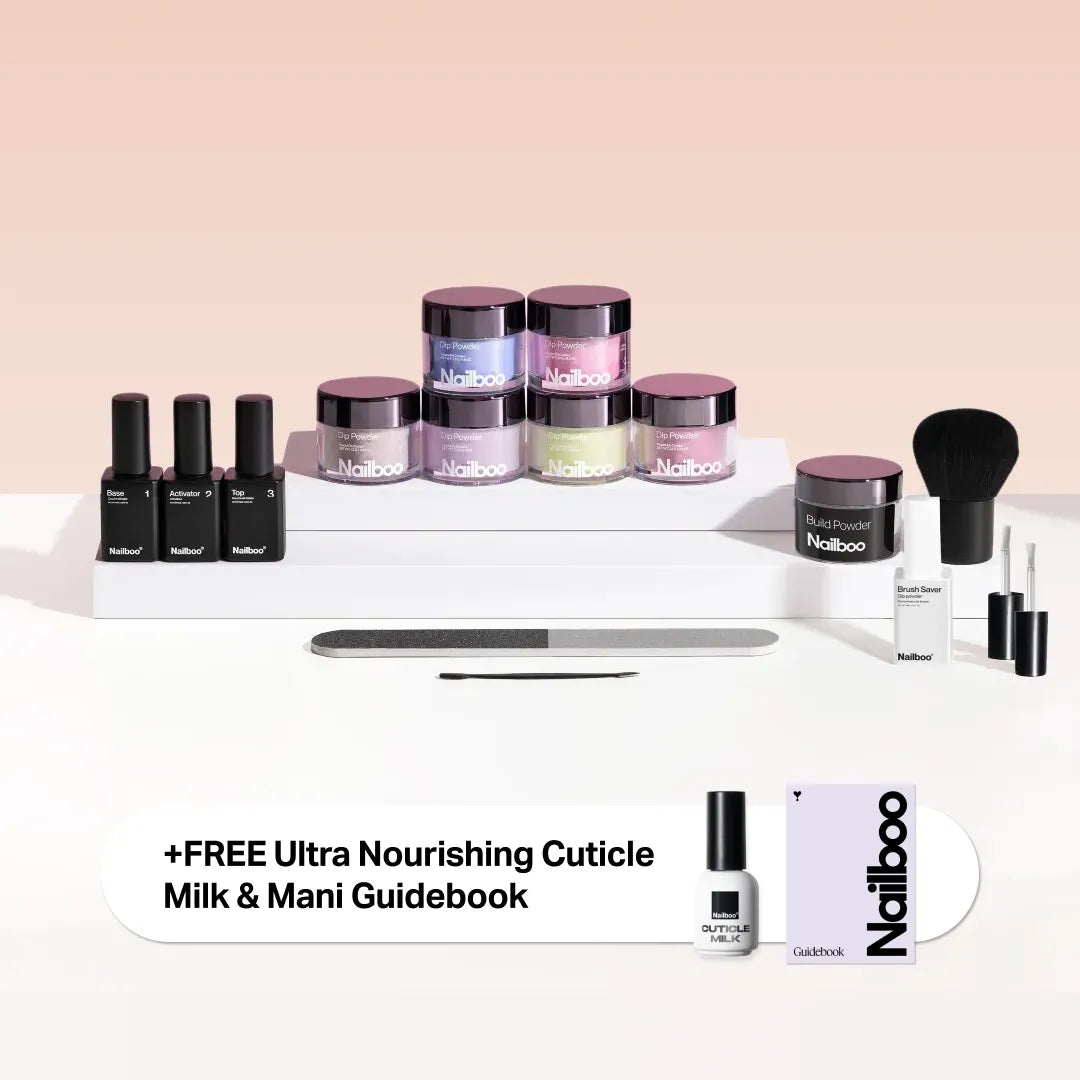 Nailboo nail kit with powders, brushes, nail files, and free cuticle milk and guidebook.