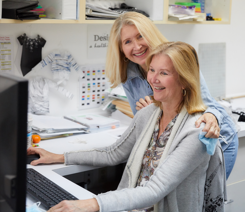 Karen and her sister, Lorraine, reviewing artwork.