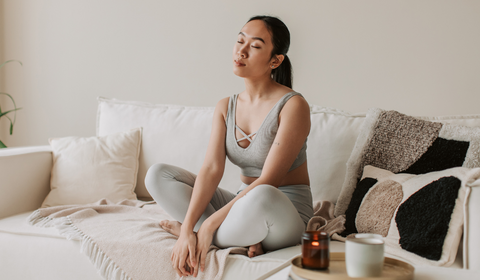 calm woman practicing mindful meditation for deep sleep, highlighting the benefits of CBD sleep gummies