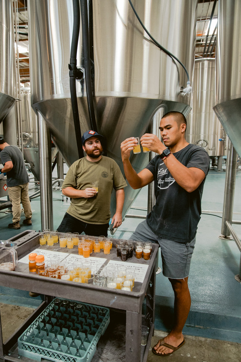 2 men tasting beer in a brewery