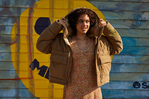 Woman in the Toad&Co Spruce Wood jacket over a dress