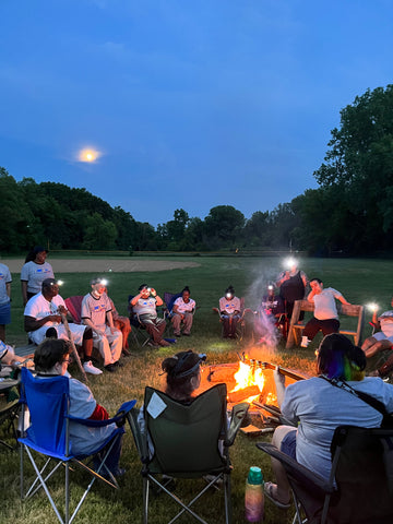 camp attendees around a campfire