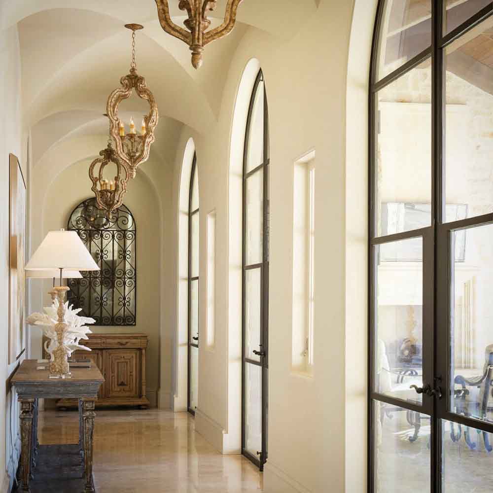 Spanish style home with groin vaulted ceiling and wooden arched doors