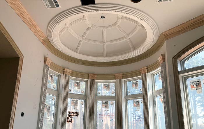 A detailed Dome Ceiling with moldings in a federal-style oval room