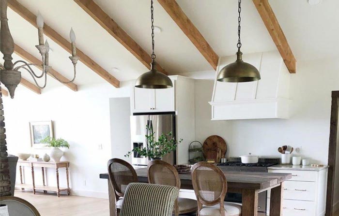 Farmhouse Range Hood in rustic kitchen with exposed beams in vaulted ceiling