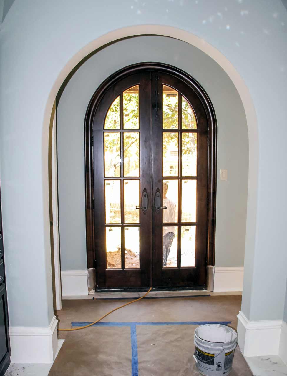 Half circle arch entry with arched wooden door